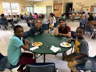Lindsey Blisko and Julia Peiris join two young refugee students for lunch.